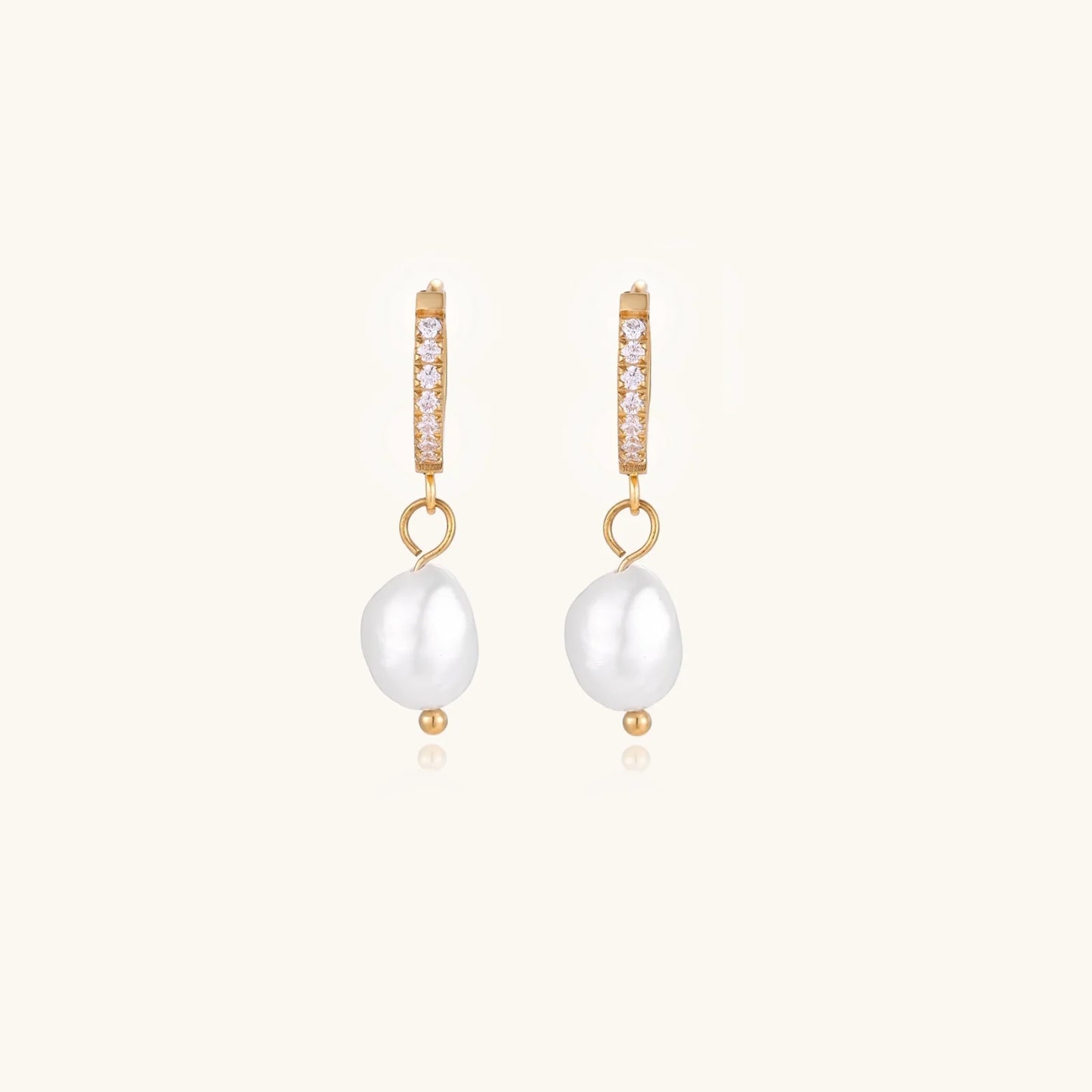 A radiant view of Pearl Drop Hoops - Freshwater Pearl - 18K Gold Plated Stainless Steel by Astral Signature, emphasizing their elegant and sophisticated look. This limited edition piece is suitable for everyday wear and makes a lovely gift for her, showcasing the beauty of Astral Design.