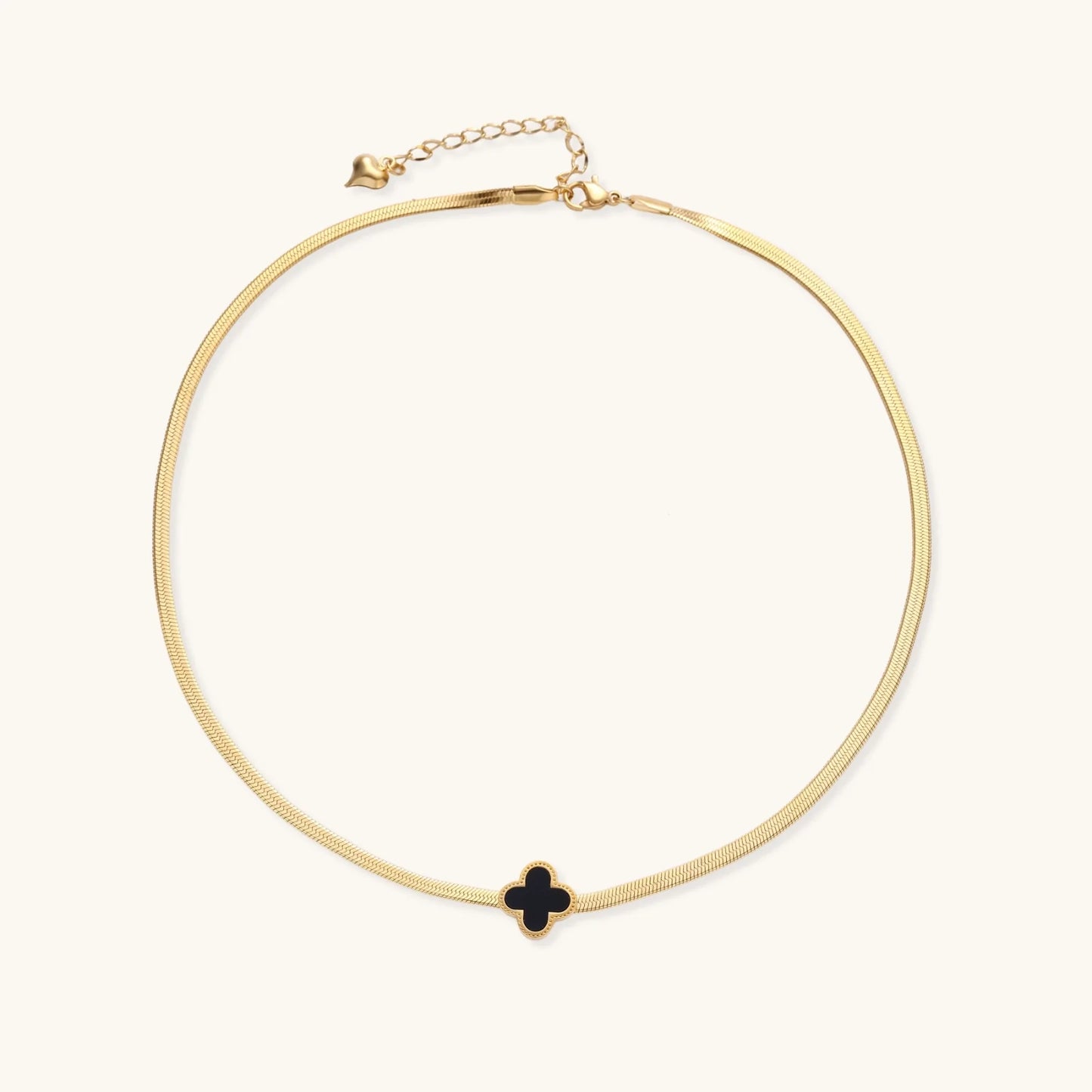A chic display of the Lucky Clover Necklace by Astral Signature, capturing the elegant black enamel clover on a gold chain, making it an ideal accessory for everyday wear or a heartfelt gift for her, featured in this limited edition Astral Design.