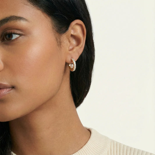 Close-up of the Crystal Pearl 18K Gold Plated Stainless Steel Hoops by Astral Signature, highlighting the intricate details of the shimmering pavé crystals and freshwater pearls. A stunning addition to your jewelry collection, this elegant design is a limited edition gift for her from Astral Signature.