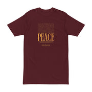 Astral Inner Peace Minimalist Tee — Gold ‘PEACE’ Script Men’s T-Shirt in a rich maroon shade, showcasing its unique graphic. A stylish gift for him, this men’s heavyweight t-shirt combines comfort with modern aesthetics.