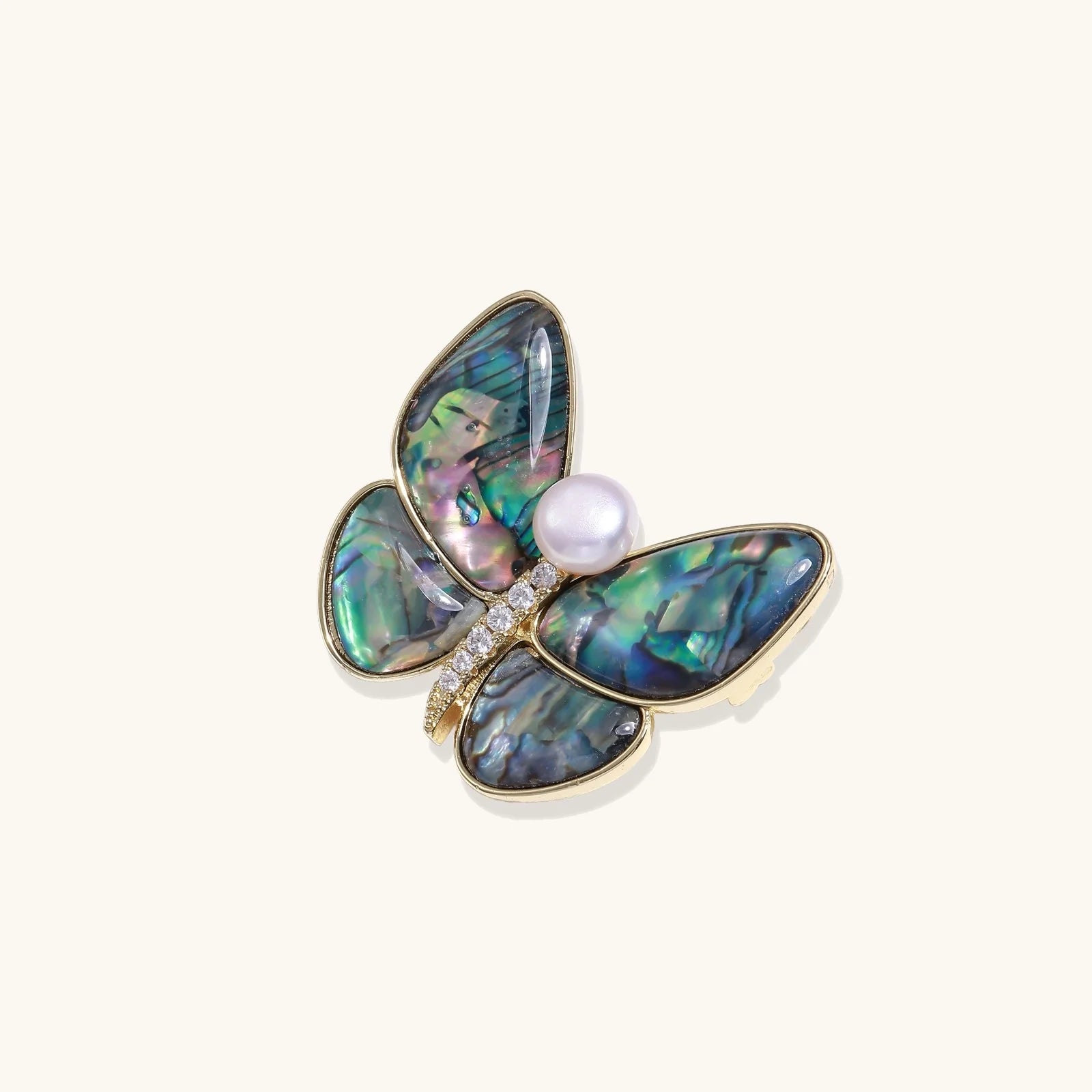 Close-up view of the Rainbow Butterfly Brooch Pin by Astral Signature, made from iridescent abalone and adorned with a freshwater pearl. Showcasing the 14K Gold Plated Eco-Brass design, perfect for stylish Jewelry Pins, Pins.
