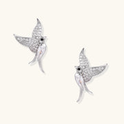 Celestial Hummingbird Earrings featured in a close-up view, showcasing their sparkling zirconia wings and elegant design. This exquisite pair, crafted by Astral Signature, is made of eco-brass with white gold plating, ideal as a gift for her and made with S925 sterling silver posts for comfort.