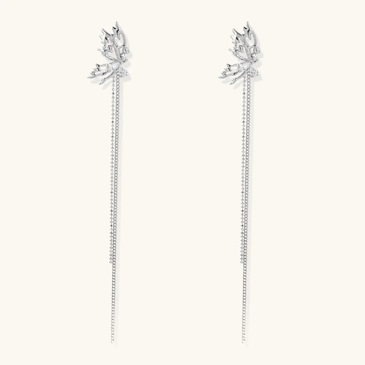 Silver-toned threader earrings featuring detailed fairy figure with wings and dual delicate chain strands, zirconia accents
