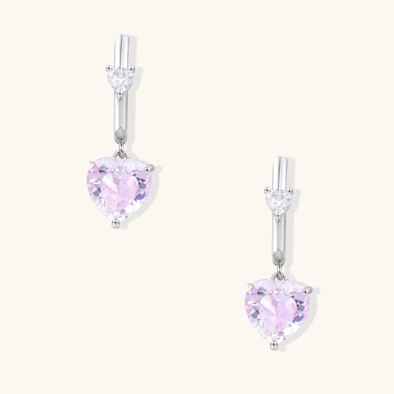 Stylish portrayal of Pink Heart Drop Hoops by Astral Signature, emphasizing the sparkly zirconia. This design of Eco-Brass earrings makes a thoughtful gift for her, showcasing White Gold Plated Eco-Brass craftsmanship.