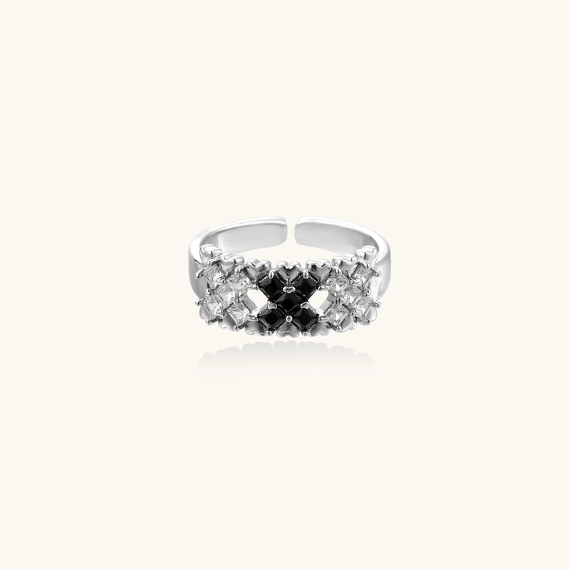 Side view of the Pixel Dream Ring — White Gold Plated Eco-Brass • Zirconia by Astral Signature, displaying its unique design with black and clear zirconia stones, contributing to its adjustable nature and suitability as an eco-brass Gift for Her.