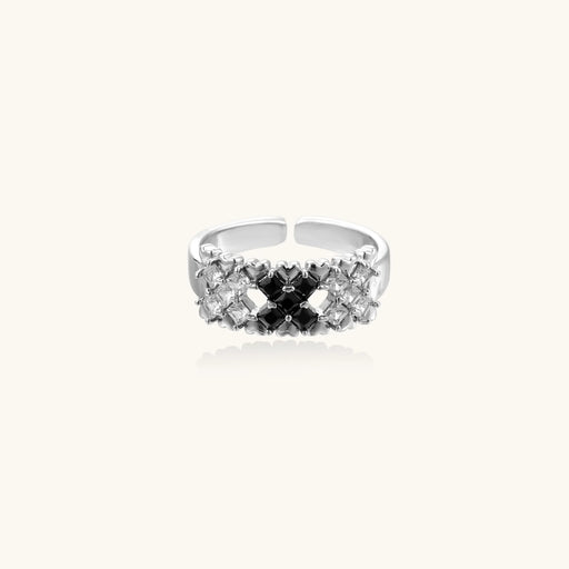 Side view of the Pixel Dream Ring — White Gold Plated Eco-Brass • Zirconia by Astral Signature, displaying its unique design with black and clear zirconia stones, contributing to its adjustable nature and suitability as an eco-brass Gift for Her.