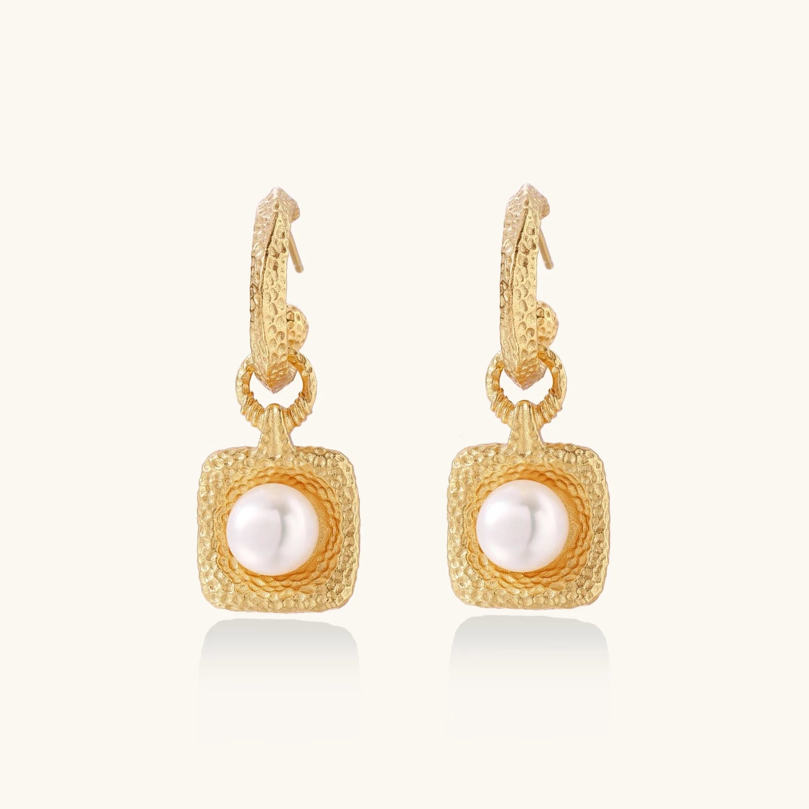 Elegant presentation of Golden Pearl Drop Hoops by Astral Signature, featuring a luminous freshwater pearl encased in a stylish hammered gold vermeil design. This limited edition earring set is perfect for everyday use and makes a thoughtful gift for her, showcasing Astral Design's unique flair.