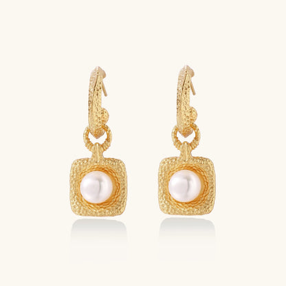 Elegant presentation of Golden Pearl Drop Hoops by Astral Signature, featuring a luminous freshwater pearl encased in a stylish hammered gold vermeil design. This limited edition earring set is perfect for everyday use and makes a thoughtful gift for her, showcasing Astral Design's unique flair.