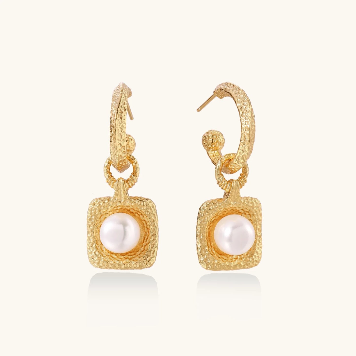 Display of Golden Pearl Drop Hoops by Astral Signature, showcasing a stunning freshwater pearl set within a beautifully textured hammered gold vermeil hoop. This piece is designed for everyday wear and is a limited edition, ideal as a gift for her. Astral Design exudes sophistication.