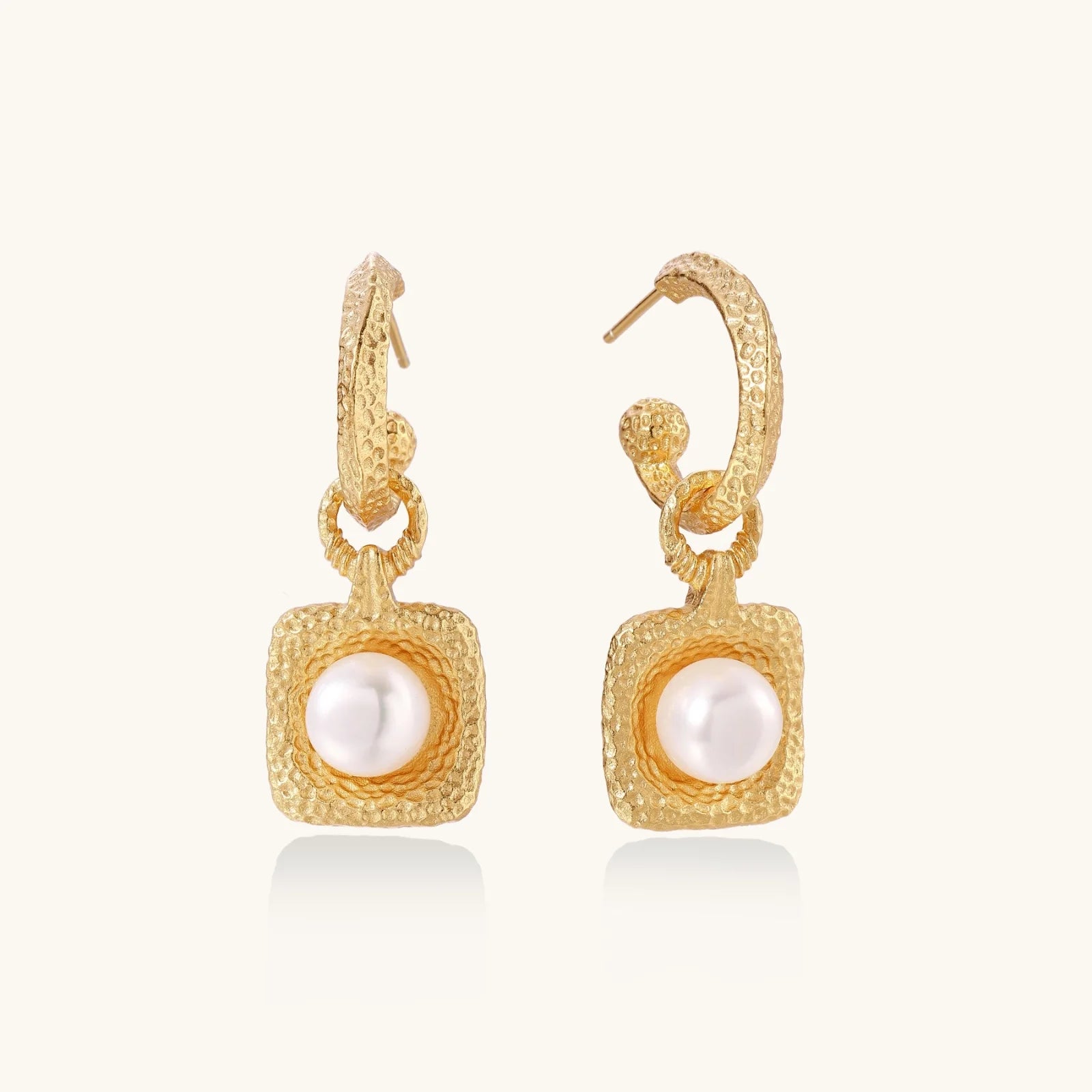 Display of Golden Pearl Drop Hoops by Astral Signature, showcasing a stunning freshwater pearl set within a beautifully textured hammered gold vermeil hoop. This piece is designed for everyday wear and is a limited edition, ideal as a gift for her. Astral Design exudes sophistication.