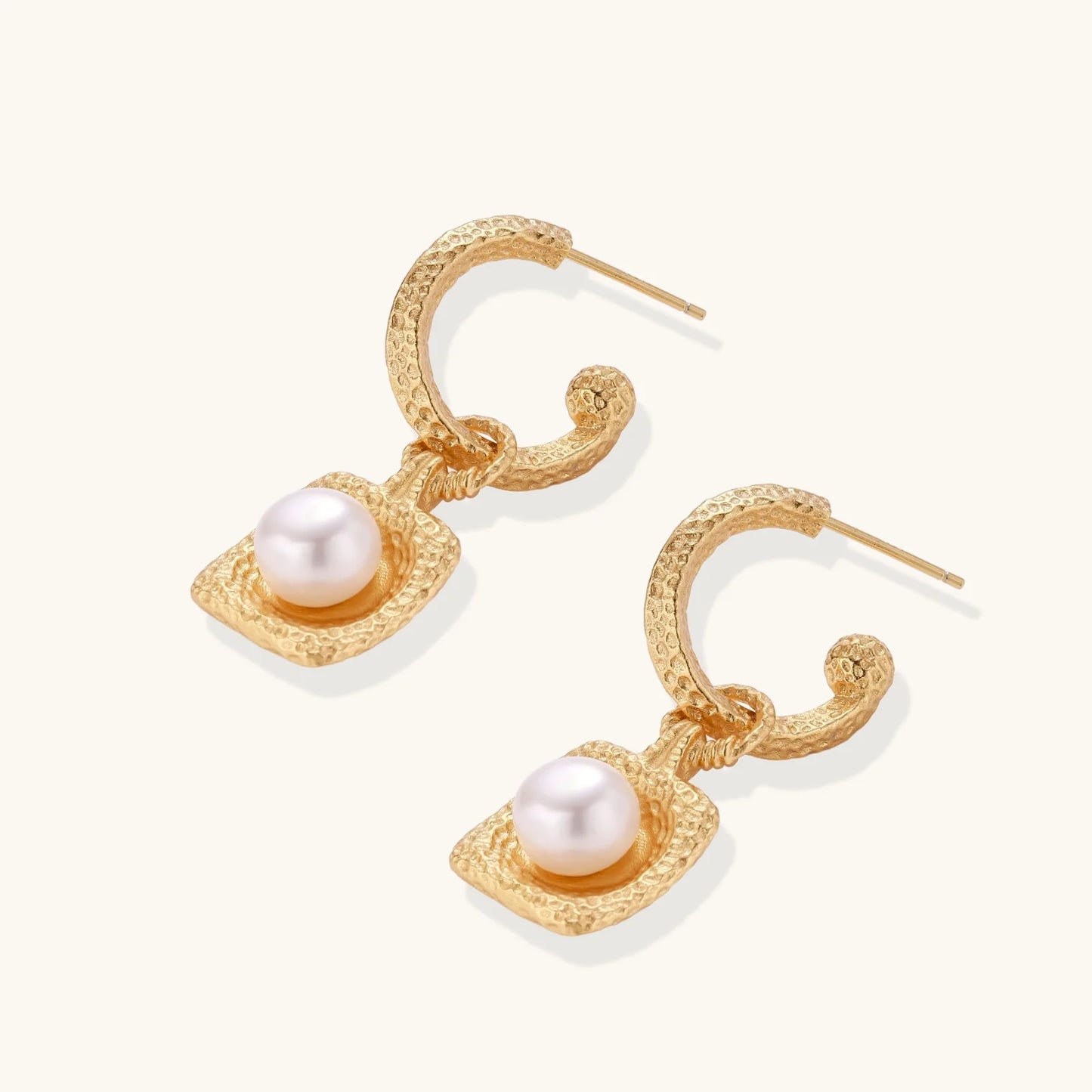 Charming layout of Golden Pearl Drop Hoops by Astral Signature, emphasizing a radiant freshwater pearl in a beautifully crafted hammered gold vermeil hoop. This limited edition jewelry piece is designed for everyday wear and serves as a perfect gift for her, showcasing the artistic vision of Astral Design.