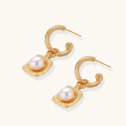 Charming layout of Golden Pearl Drop Hoops by Astral Signature, emphasizing a radiant freshwater pearl in a beautifully crafted hammered gold vermeil hoop. This limited edition jewelry piece is designed for everyday wear and serves as a perfect gift for her, showcasing the artistic vision of Astral Design.