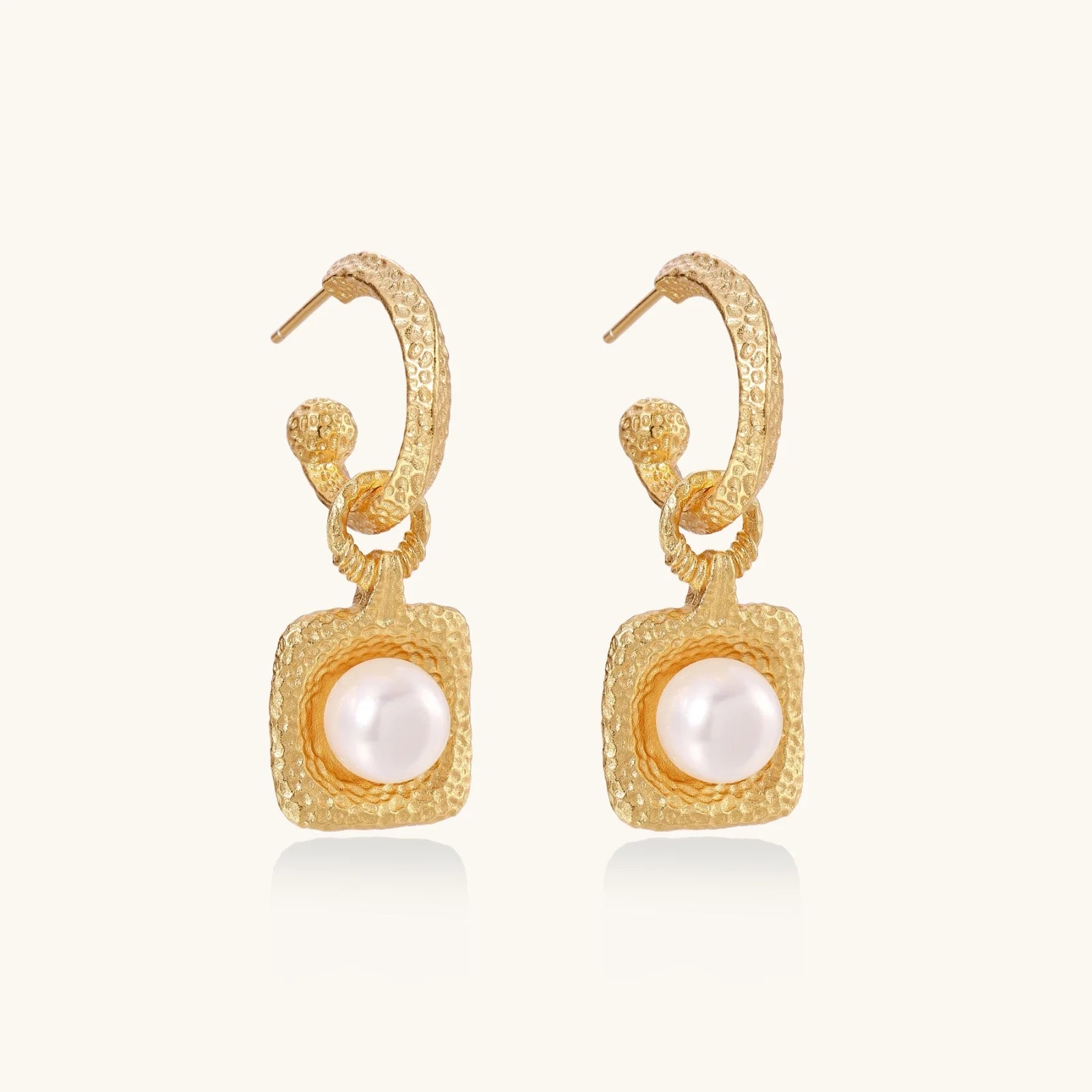 Artistic view of the Golden Pearl Drop Hoops by Astral Signature, highlighting a delicate freshwater pearl nestled in a textured hammered gold vermeil setting. Ideal for everyday wear, these limited edition earrings are a perfect gift for her and embody the distinctive elegance of Astral Design.