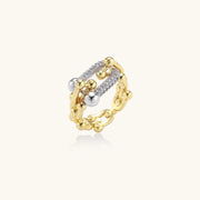 An artistic view of the Chain Link Power Ring by Astral Signature, highlighting its stunning blend of cubic zirconia and eco-brass in an innovative design. This versatile ring is perfect for everyday wear and serves as a thoughtful gift for her, featured in the limited edition collection from Astral Design.