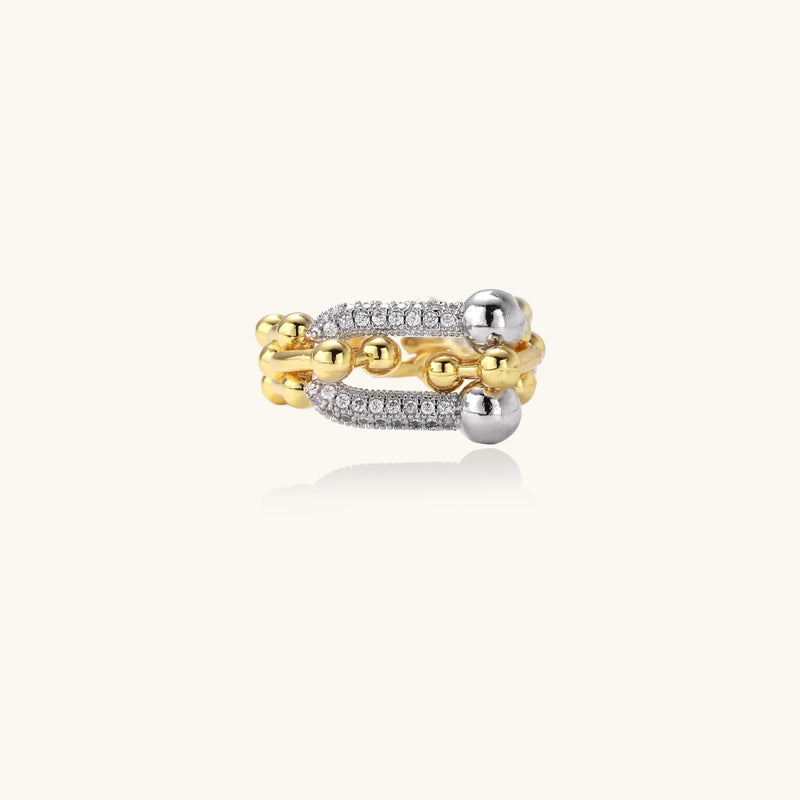 An elegant display of the Chain Link Power Ring by Astral Signature, emphasizing its unique design with gold and cubic zirconia elements. This ring is ideal for everyday wear and serves as a perfect gift for her, designed as part of a limited edition collection by Astral Design.