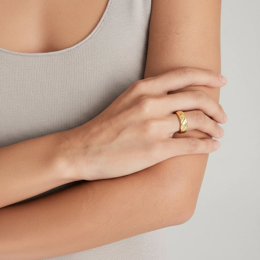 Close-up of the Twisted Luxe Band by Astral Signature, highlighting the exquisite braided texture and 18K gold plating. This versatile ring is ideal for everyday wear and serves as a chic gift for her, combining elegance with durability. Crafted by Astral Design, this limited edition piece adds a touch of sophistication to any jewelry collection.