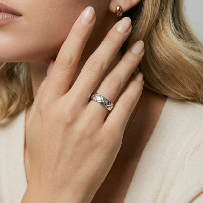 The Quilt Steel Ring by Astral Signature showcased on a model's hand, highlighting its elegant texture and unique woven pattern. This statement piece is an ideal gift for her from the exclusive Astral Design collection.