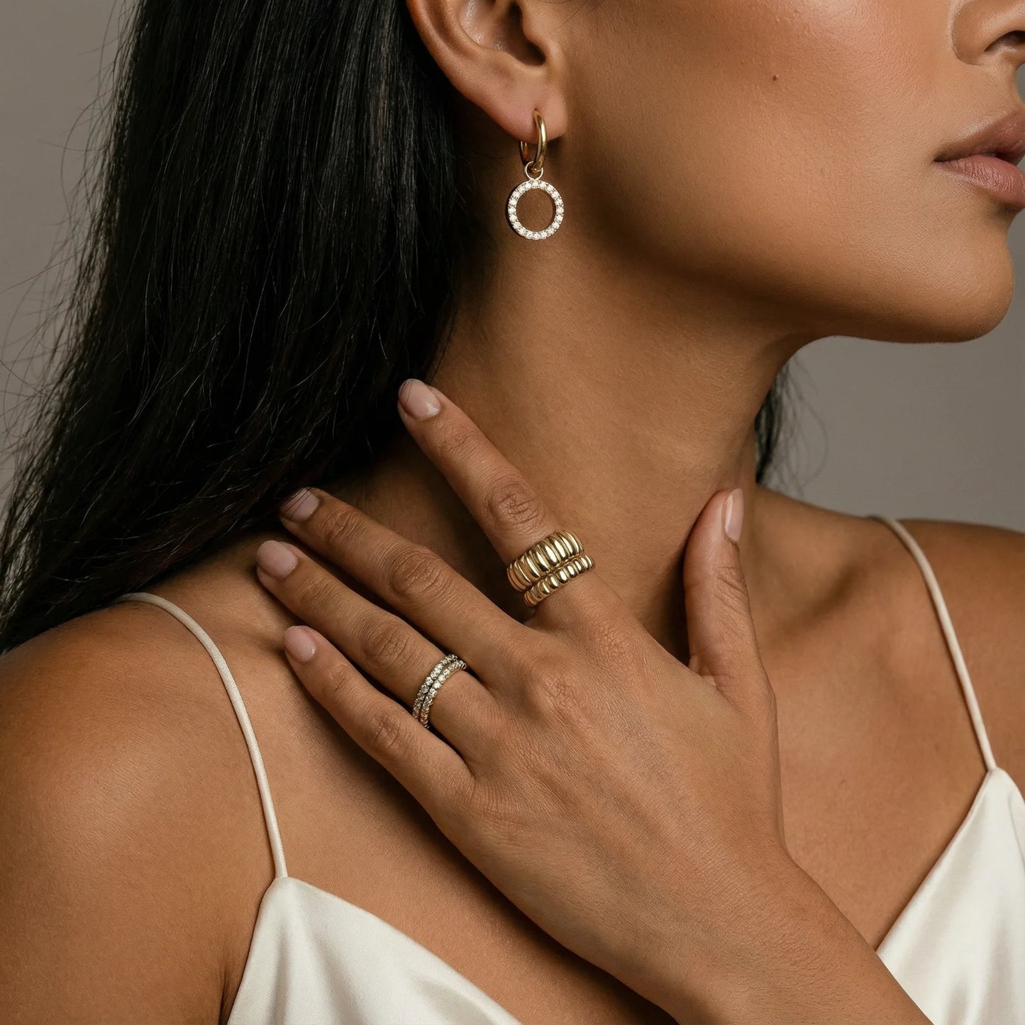 Close-up of a stylish woman wearing Gold Plated Halo Circle Hoops By Astral Signature, exuding sophistication with CZ-studded details. This image represents Astral Design’s exquisite collection, ideal for a Gift for Her within Astral Signature's Limited Edition range.