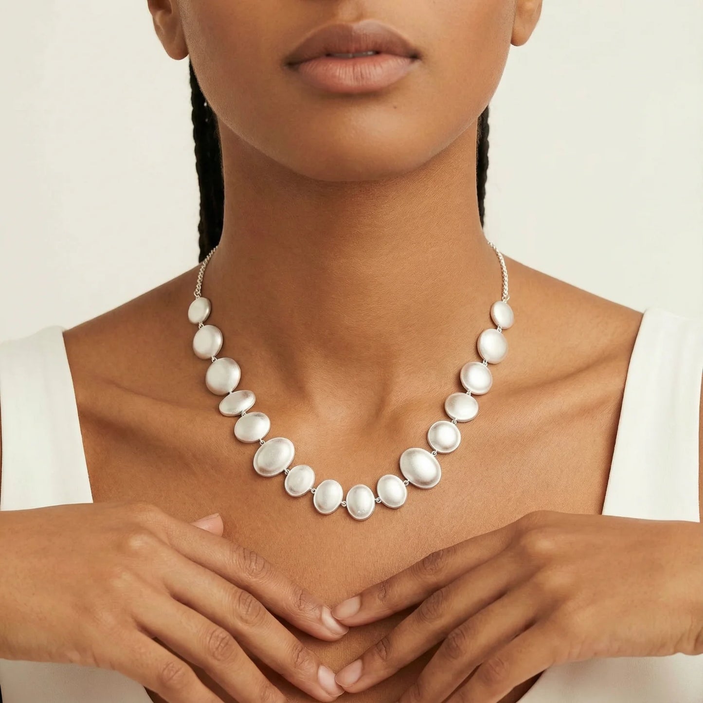 Model wearing the Lunar Pearl Arc Necklace - Sterling Silver by Astral Signature, featuring elegant pearlescent silver bubbles, perfect for any occasion. This limited edition piece from Astral Design is an ideal gift for her.