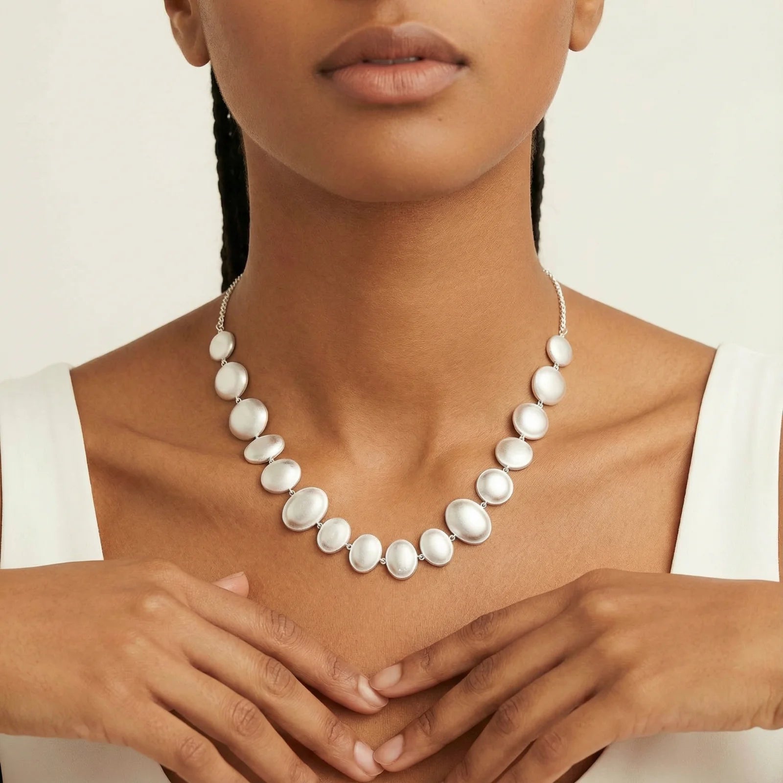 Model wearing the Lunar Pearl Arc Necklace - Sterling Silver by Astral Signature, featuring elegant pearlescent silver bubbles, perfect for any occasion. This limited edition piece from Astral Design is an ideal gift for her.