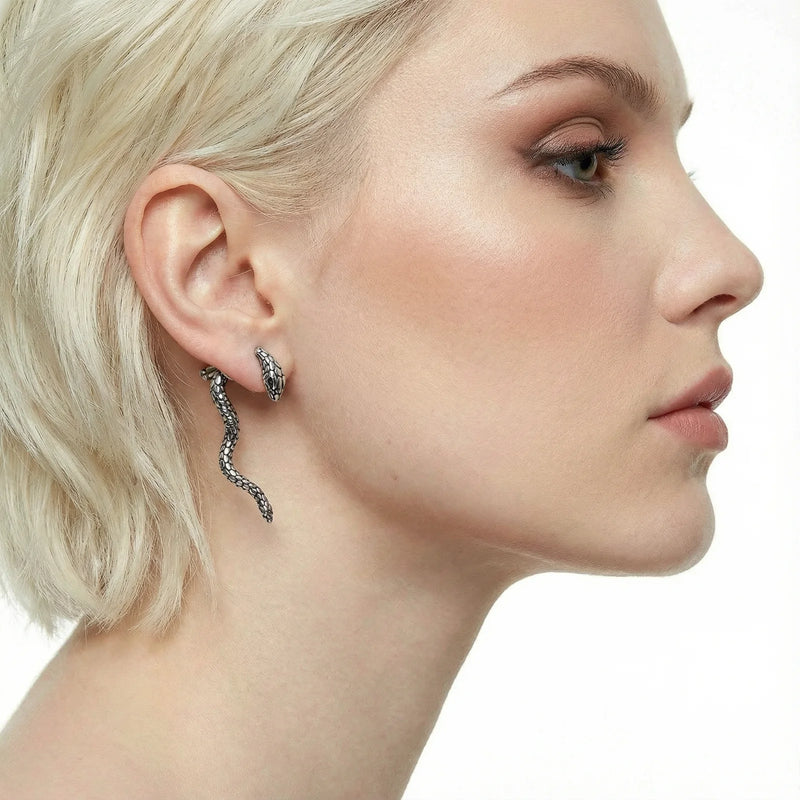 Profile view of a model wearing Serpent Spell Earrings by Astral Signature, highlighted against a minimalist background. These Eco-Brass earrings with white gold plating are an ideal gift for her, featuring secure and hypoallergenic Sterling Silver (S925) posts.