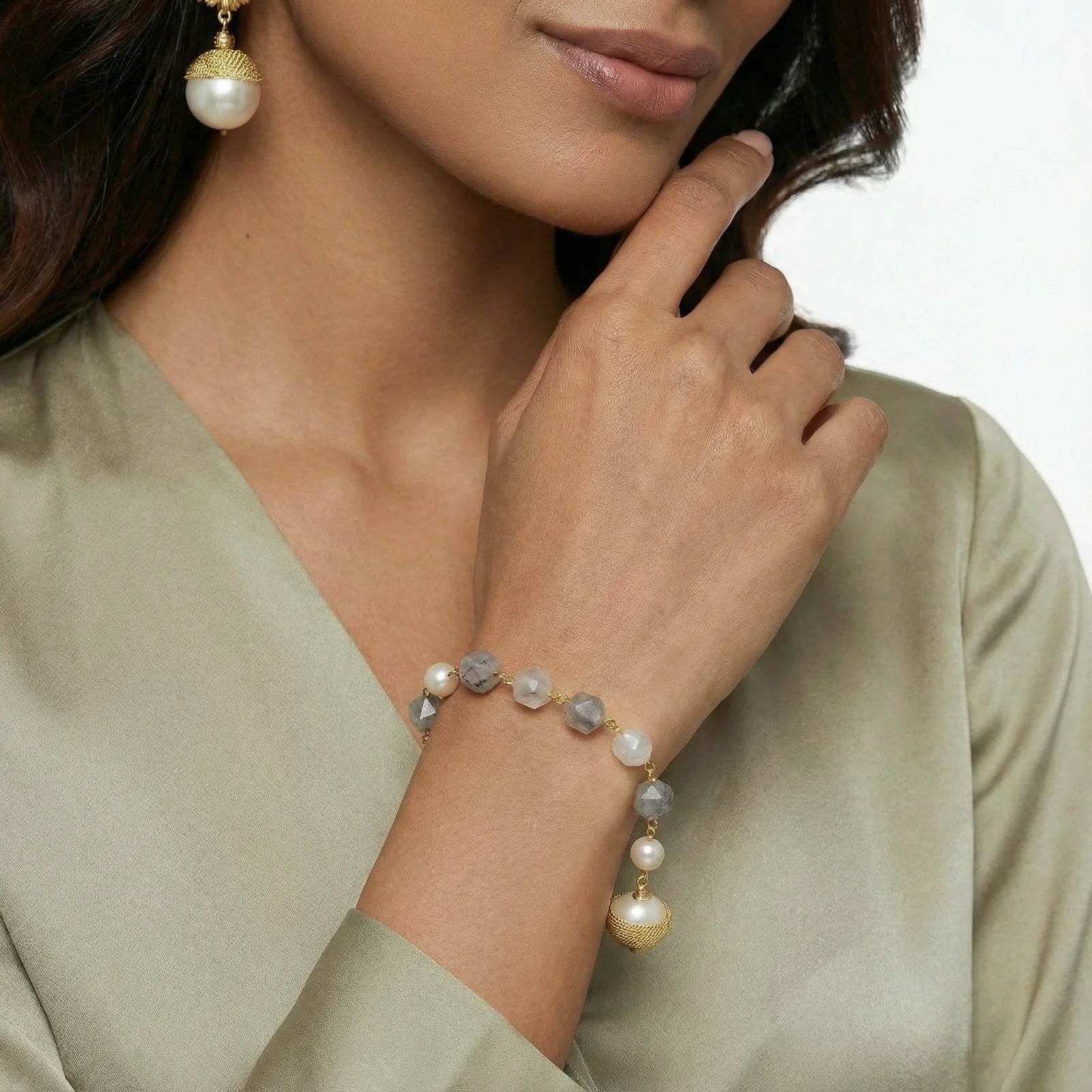 A model showcasing the Baroque Pearl Crystal Bracelet from Astral Signature, featuring lustrous freshwater pearls and cloudy quartz. This elegant piece, crafted with 14K Gold Plated Eco-Brass, is perfect for everyday wear and makes a great gift for her. Explore the limited edition Astral Design collection.