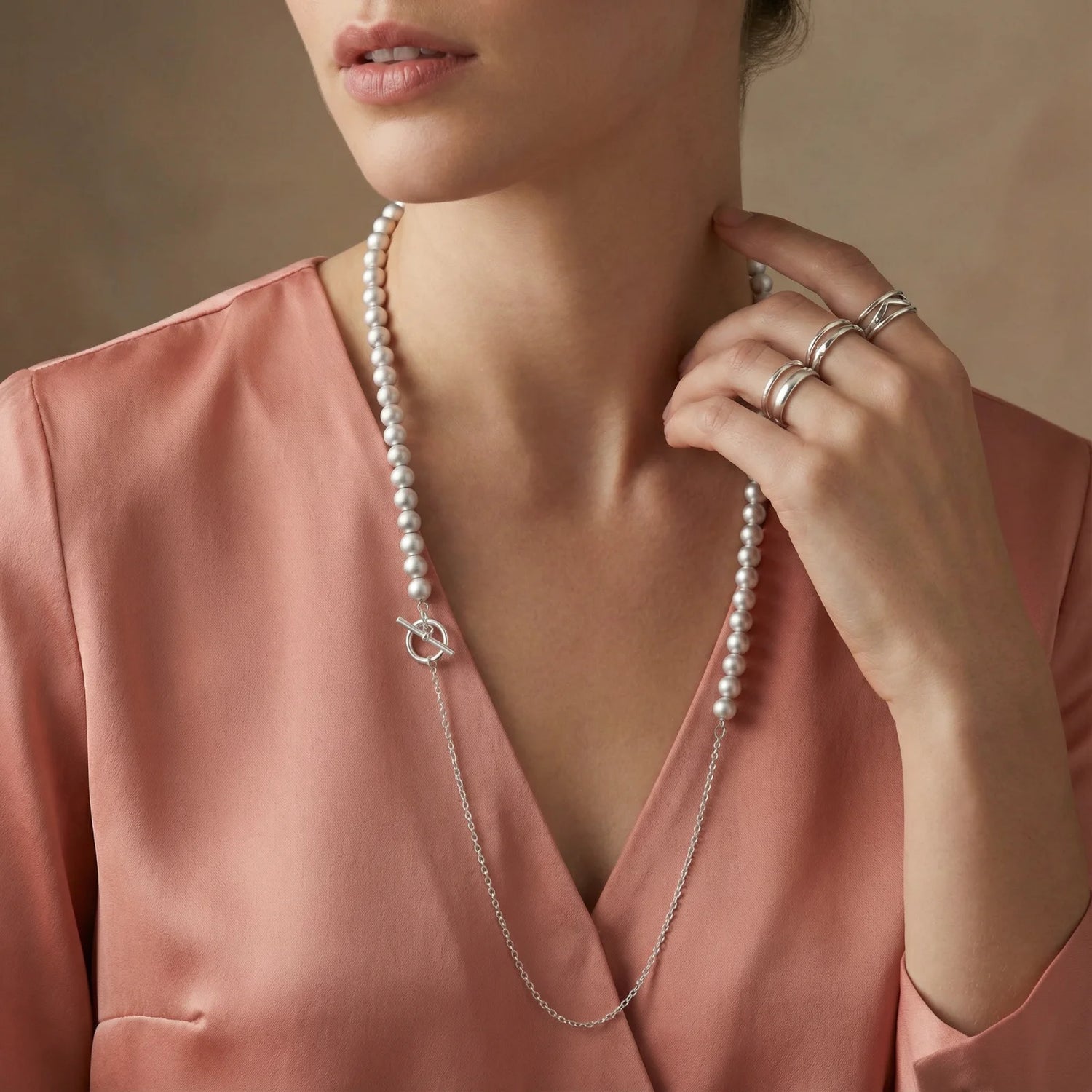 A chic woman wearing the Silver Sphere Gradient Necklace by Astral Signature, showcasing its elegant design and versatility. This sterling silver necklace complements her stylish outfit while adding a touch of whimsy to her look, proving that great accessories can make you feel as fabulous as a unicorn at a tea party!