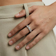 A stylish shot of the Geometric Luxe Ring by Astral Signature worn on a hand, emphasizing its unique Eco-Brass layout with elegant zirconia details and white gold finish.