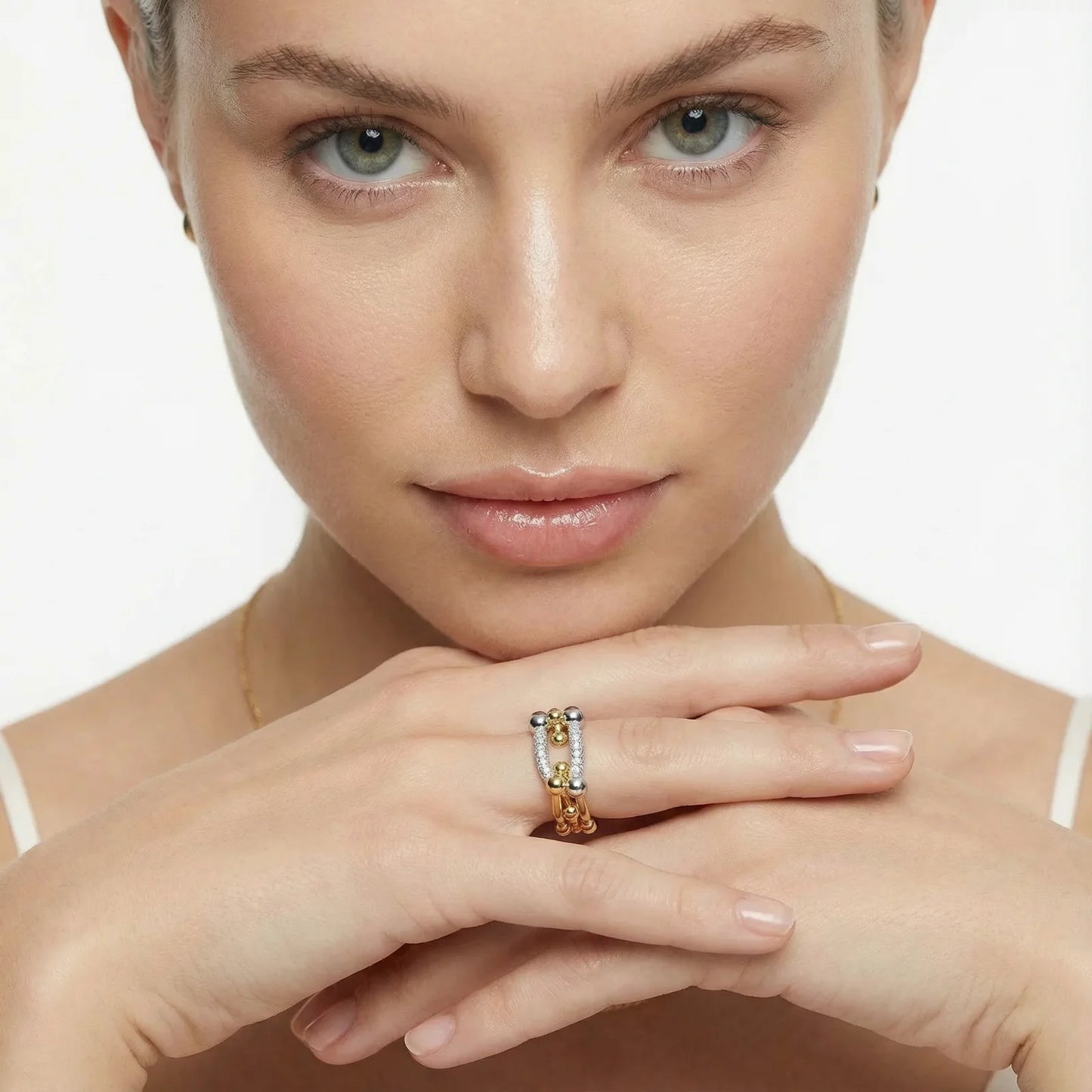 A close-up of a model wearing the Chain Link Power Ring by Astral Signature, showcasing sparkling cubic zirconia and 18K gold-plated eco-brass. This elegant piece embodies contemporary style, making it a perfect choice for everyday wear or a thoughtful gift for her. Explore this limited edition design from Astral Design.