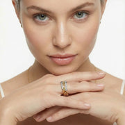 A close-up of a model wearing the Chain Link Power Ring by Astral Signature, showcasing sparkling cubic zirconia and 18K gold-plated eco-brass. This elegant piece embodies contemporary style, making it a perfect choice for everyday wear or a thoughtful gift for her. Explore this limited edition design from Astral Design.