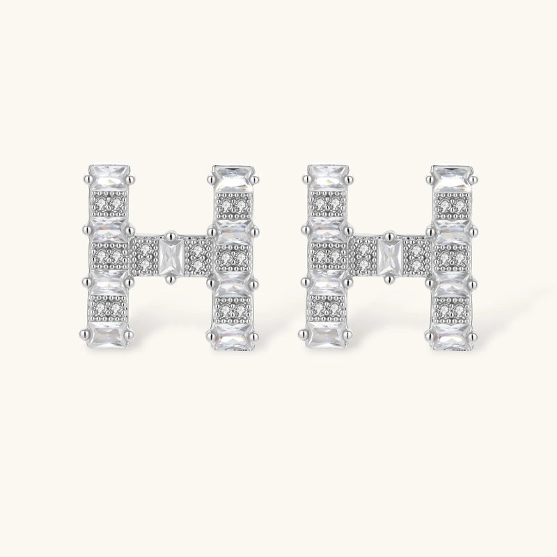 Close-up of the Crystal H Initial Set stud earrings from Astral Signature, showcasing a refined 'H' design with zirconia embellishments.