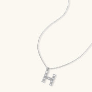 Minimalist Crystal H Initial Set pendant necklace by Astral Signature, featuring a delicate 'H' charm adorned with zirconia.