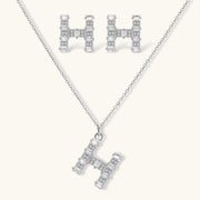 Crystal H Initial Set earrings and pendant necklace designed by Astral Signature, featuring a geometric 'H' silhouette adorned with sparkling zirconia.