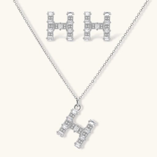 Crystal H Initial Set earrings and pendant necklace designed by Astral Signature, featuring a geometric 'H' silhouette adorned with sparkling zirconia.