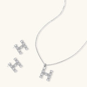 The complete Crystal H Initial Set from Astral Signature, featuring matching earrings and a pendant necklace with a sparkling 'H' design.