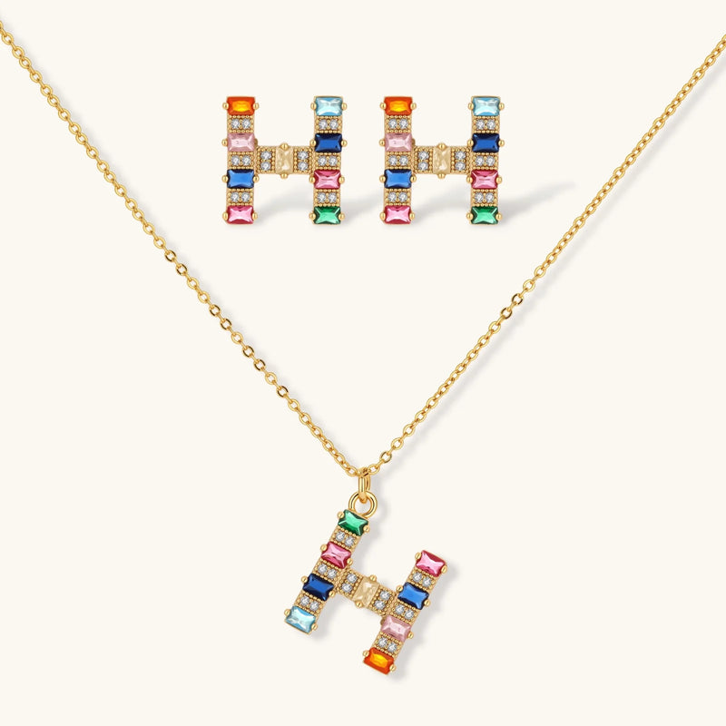Elegant Crystal H Initial Set from Astral Signature, showcasing a vibrant 'H' pendant necklace and earrings adorned with colorful gemstones.