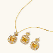 Heirloom Square square gold jewelry set displayed with a dazzling yellow pendant and earrings set featuring zirconia by Astral Signature.