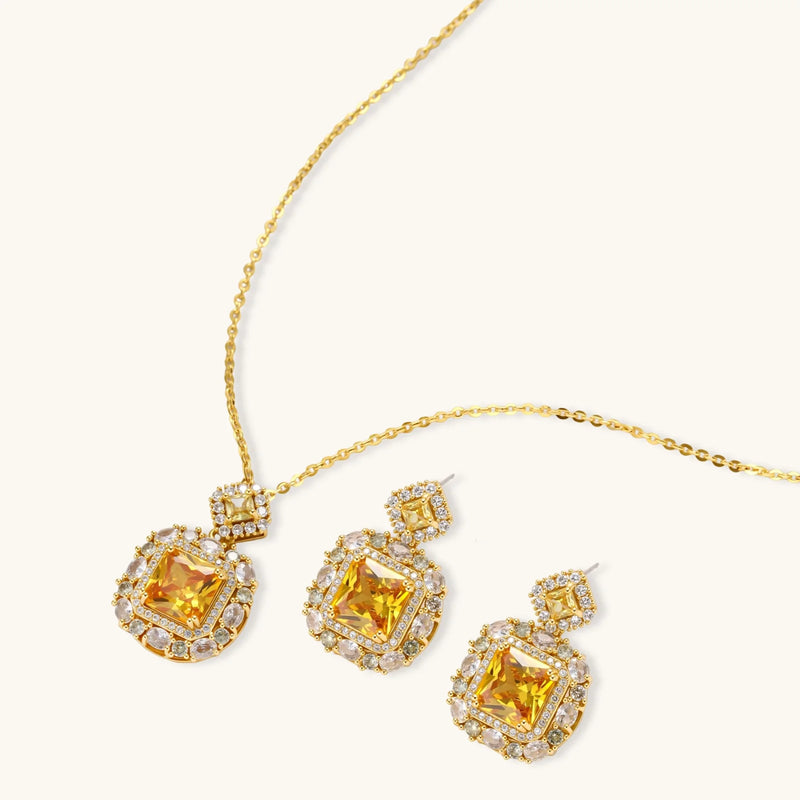 Heirloom Square square gold jewelry set displayed with a dazzling yellow pendant and earrings set featuring zirconia by Astral Signature.