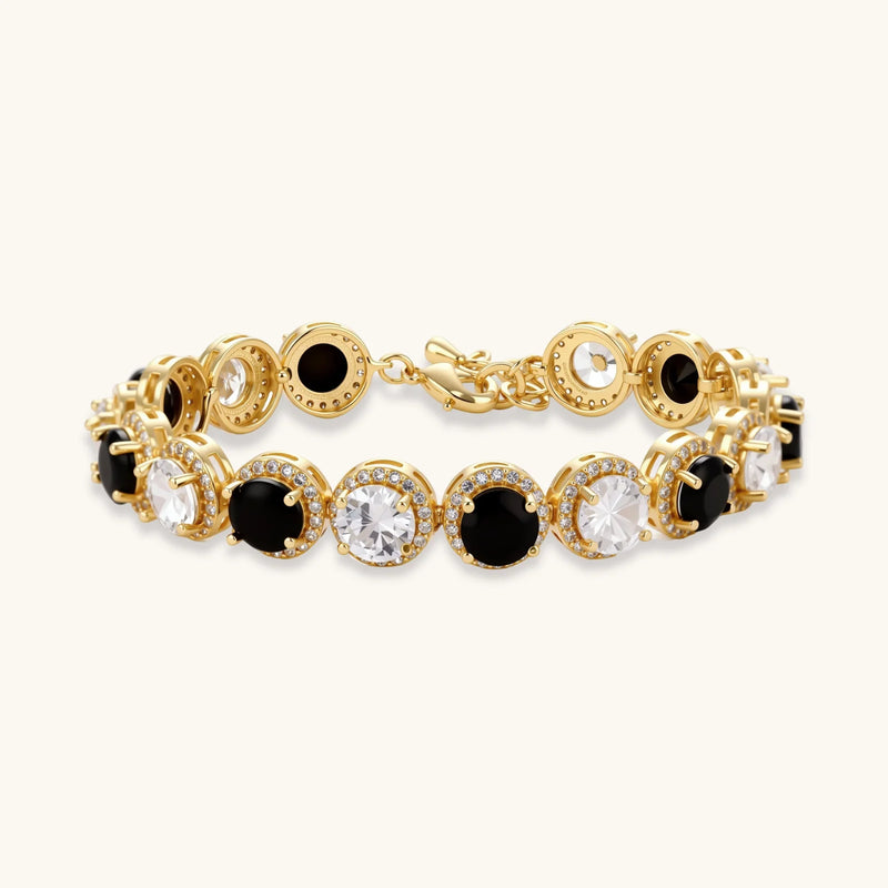 Detailed view of the bracelet from the Astral Signature™ Noir Luxe black and gold jewelry set, featuring alternating black and clear zirconia stones.