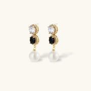 Close-up of the statement earrings from the Astral Signature™ Noir Luxe black and gold jewelry set, designed with dual zirconia accents and pearl drops.