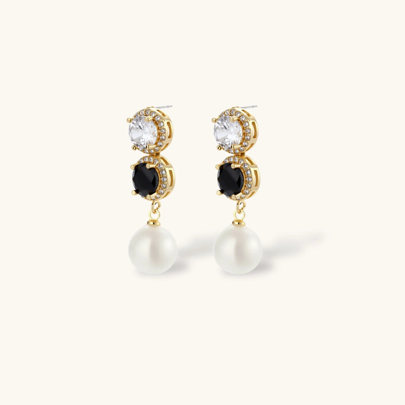 Close-up of the statement earrings from the Astral Signature™ Noir Luxe black and gold jewelry set, designed with dual zirconia accents and pearl drops.