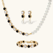 Astral Signature™ Noir Luxe black and gold jewelry set featuring a stunning necklace, statement earrings, and a coordinating bracelet with zirconia.