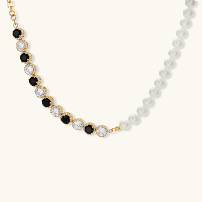 Detailed shot of the necklace from the Astral Signature™ Noir Luxe black and gold jewelry set, highlighting the charm of both black and clear zirconia.