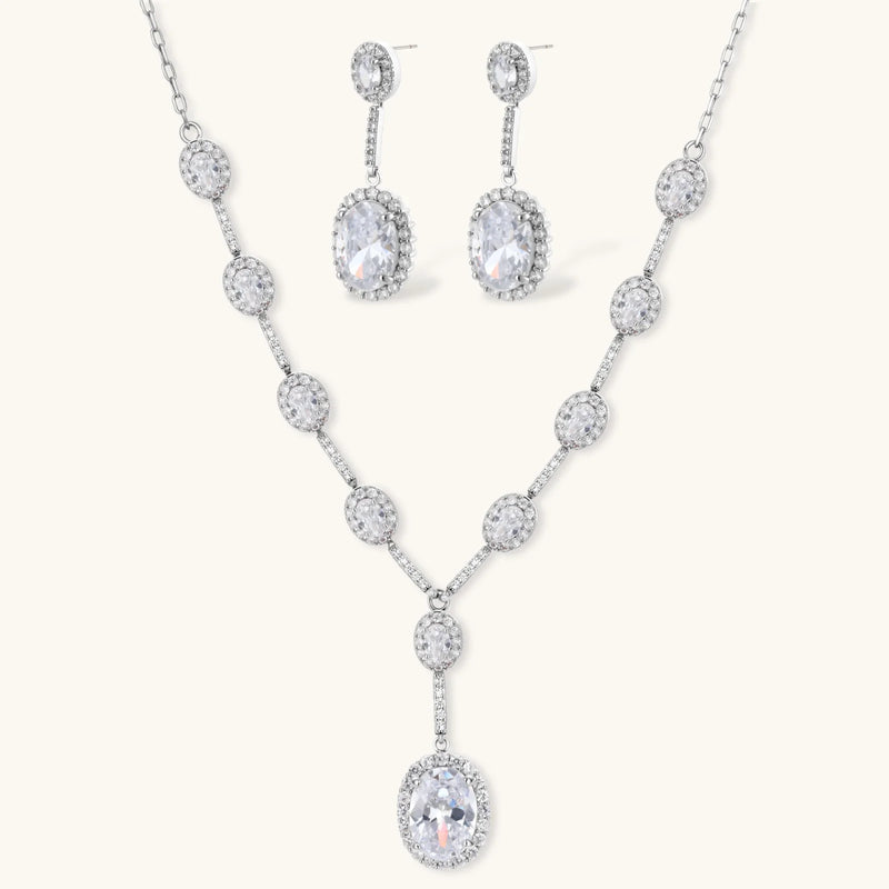 Celestial Cascade Set by Astral Signature featuring a Y-shaped necklace and matching drop earrings adorned with zirconia stones and white gold plating.