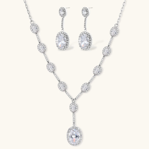 Celestial Cascade Set by Astral Signature featuring a Y-shaped necklace and matching drop earrings adorned with zirconia stones and white gold plating.