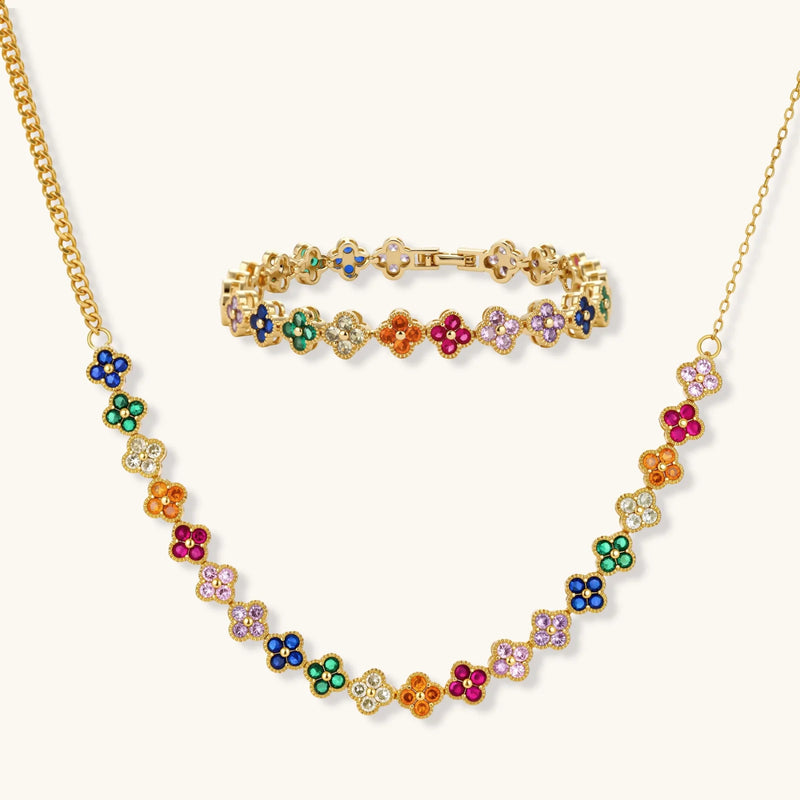 Lucky Clover Garden Set by Astral Signature featuring a vibrant necklace and bracelet adorned with rainbow zirconia stones, showcasing a delicate clover motif.