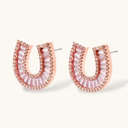 Close-up view of the earrings from the gold horseshoe jewelry set by Astral Signature, adorned with shimmering zirconia stones.