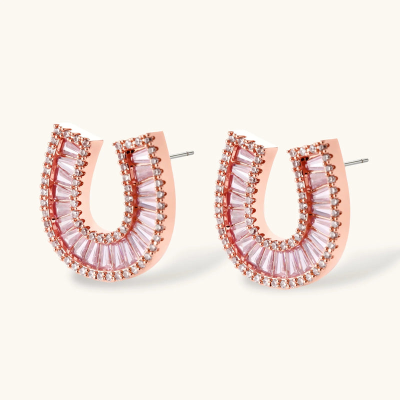 Close-up view of the earrings from the gold horseshoe jewelry set by Astral Signature, adorned with shimmering zirconia stones.