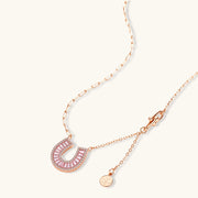 Gold horseshoe jewelry set necklace displayed prominently, crafted by Astral Signature with sparkling zirconia accents.