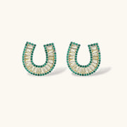 Detailed view of earrings from the gold horseshoe jewelry set by Astral Signature, showcasing intricate zirconia embellishments.